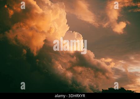 Dramatic sunset clouds with hues of gold and orange on the horizon, highlighting nature's beauty and atmospheric phenomena. Elba Italy Stock Photo