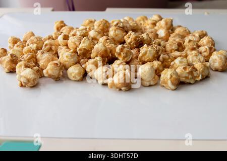 Caramel popcorn scattered on white background close perspective Stock Photo
