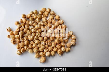 Caramel popcorn scattered on white background close perspective Stock Photo