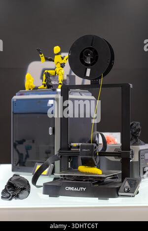3D printer printing a bright yellow object model. Creality 3D printing machine. 3d printing of plastic filament. Minsk, Belarus - March 16, 2025 Stock Photo