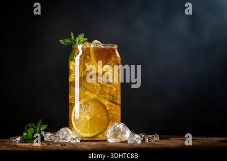 Summer drink Iced tea with lemon slices and mint on dark background Stock Photo