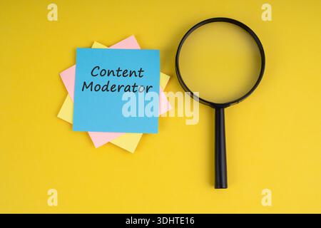 Magnifying glass and adhesive note with text Content Moderator on yellow background Stock Photo