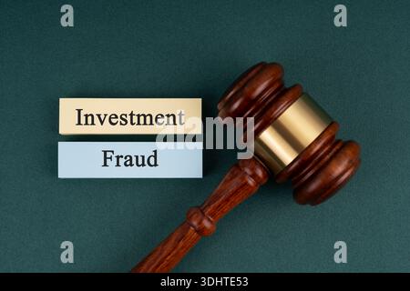 Gavel and Investment Fraud concept on green background Stock Photo