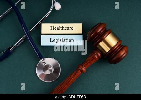 Stethoscope and gavel Healthcare Legislation concept on green concept Stock Photo