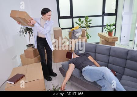 Unexpected chaos in a home office as a playful surprise unfolds between colleagues during a busy workday Stock Photo
