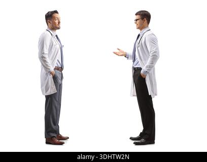 Two male doctors in lab coats talking and discussing against a white background Stock Photo