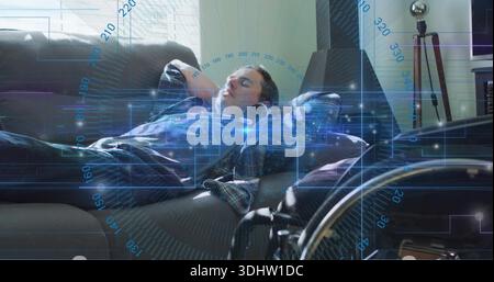 Reclining mid-adult man wearing plaid shirt on sofa in living room, with wheelchair and HUD overlay Stock Photo