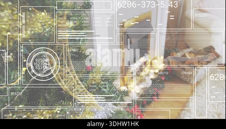 Displaying decorated evergreen tree glowing with warm string lights in living room, HUD overlay Stock Photo