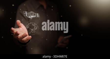 Space based data center powered by solar energy. Man hand holding satellite orbiting around the globe. AI computing infrastructure, global connectivit Stock Photo