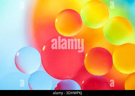 Oil drops in water and air bubbles, selective focus. Bright multicolored fantasy rainbow background. macro photo. Stock Photo