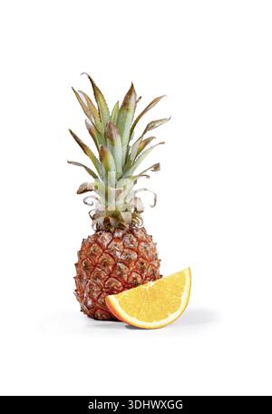 Fresh pineapple and orange slices arranged on a white background, vertical, no people Stock Photo