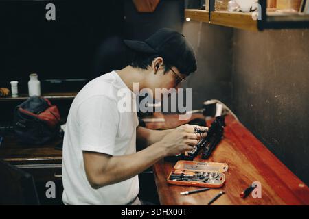 Technician using screwdriver case on the desk. Technician using screwdrivers on an electronic board on the desk Stock Photo