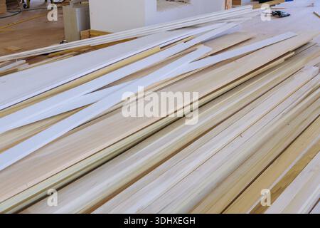 Workers gather various wooden pieces on large table in tools materials are nearby for future construction tasks. Stock Photo