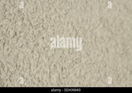 Beige Coarse Plaster Wall Blurred Background Texture. Stock Photo