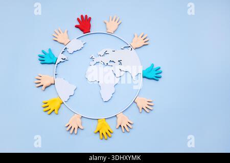 Diverse hands embracing earth globe representing global unity Stock Photo