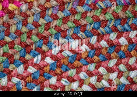 Details of the curved patterns in a colorful woven fabric of a throw rug Stock Photo