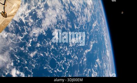 A view of Earth from the International Space Station with the moon in the distance. A photograph taken from the International Space Station on 19 August 2021. An optimised version of an original NASA image: Credit: NASA/ESA. EDITORIAL USE ONLY. Stock Photo