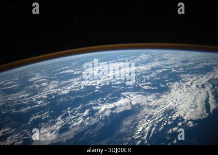 Earth viewed from orbit. The visible curve is the 'limb' of the Earth, with the thin glowing band representing the atmosphere. A photograph taken from the International Space Station on 22 October 2021. An optimised version of an original NASA image: Credit: NASA Stock Photo