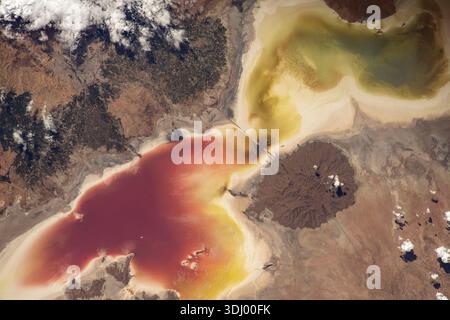 Lake Urmia in northwest Iran, once a major saltwater lake, has experienced depletion due to drought, dam construction, and agriculture. This caused high salinity and red algae growth. Restoration efforts and decreased water use have helped to partially replenish the lake. A photograph taken from the International Space Station on 30 July 2022. An optimised version of an original NASA image: Credit: NASA/SCristoforetti Stock Photo