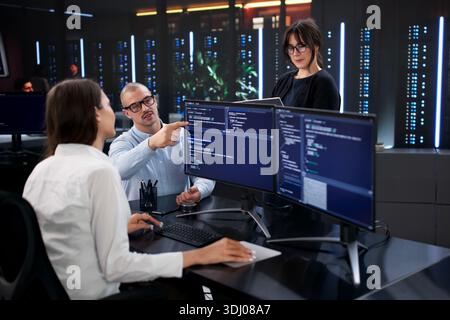 Software Developer Team Analyzing Business Data On Office Computer Screens Stock Photo
