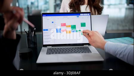 Busy Corporate Executives Scheduling Online Appointments And Meetings On Laptop Stock Photo