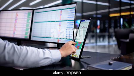 Hispanic Accountant Analyzing Financial Data On Business Desktop Monitor Stock Photo