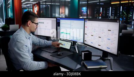 Male Financial Accountant And Analyst Checking Charts On Desktop Computer. Stock Photo