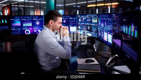 Stressed Accountant Analyzing Budget Data On Office Computer Screen. Stock Photo