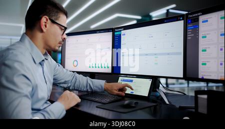 Busy Office Worker Using Desktop Computer For Business Communication Tasks. Stock Photo