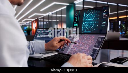 Male Engineer Developing AI Technology Using Multiple Computer Screens At Office Stock Photo