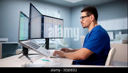 Hispanic Doctor Using Spreadsheet To Manage Medical Billing Data Efficiently Stock Photo