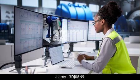 Female Engineer Creating 3D CAD Drawings Of Industrial Plant Layout Stock Photo