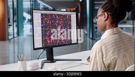 Hardworking African American Woman Analyzing Big Dataset On Office Computer. Possible Professions: Data Analyst Stock Photo