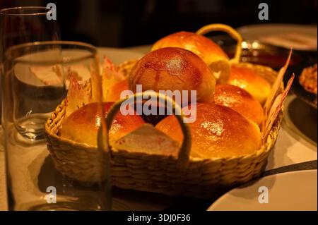 Freshly baked pastries on the table in a wicker basket Stock Photo