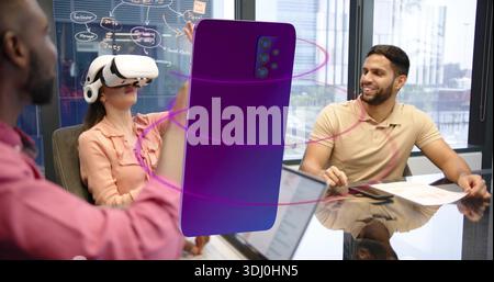 Reaching woman in peach top in white VR headset touching purple phone hologram at conference table Stock Photo