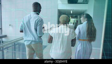Walking three coworkers in office clothes talking in office corridor with glass railing, teal HUD Stock Photo