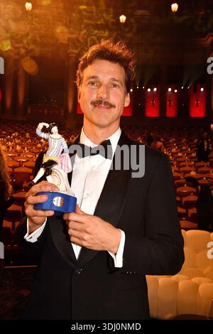Award winner Florian David Fitz poses on stage at the Bavarian Film