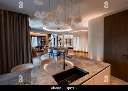 Contemporary luxury apartment interior with marble island and lounge Stock Photo