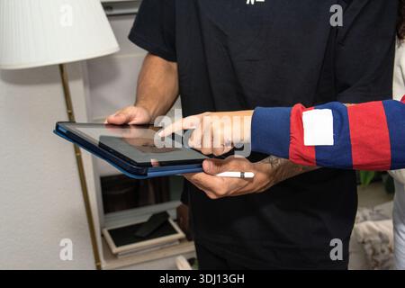 Two people collaborating on digital tablet using stylus Stock Photo