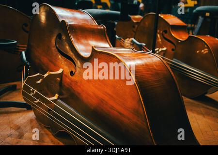 Symphonic double bass on the floor of the big stage of the concert hall. Stock Photo