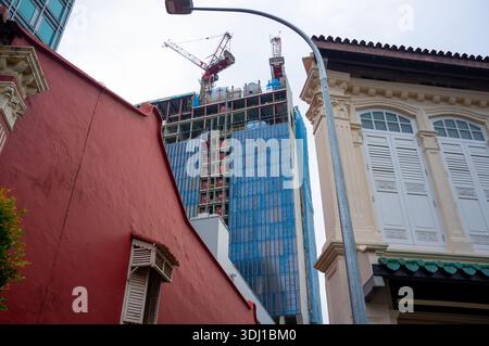 Construction work on new high-rise building at Emerald Link viewed from Emerald hill with Shophouses in the foreground. Stock Photo
