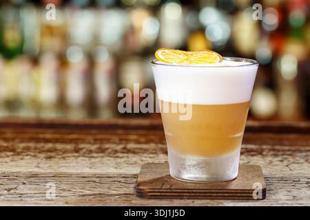 Refreshing cocktail whiskey sour on the bar in a restaurant or pub, space for text design Stock Photo
