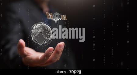 Data center powered by solar energy concept. Hand holds earth with orbital satellite in binary code. Sustainable renewable power for space based datum Stock Photo