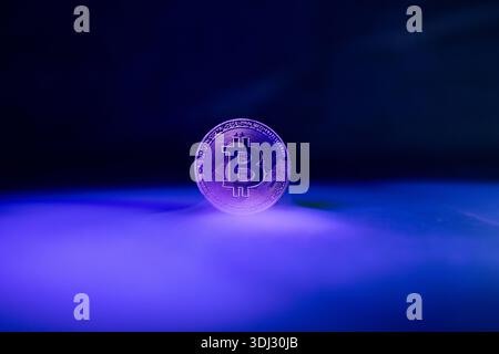 Bitcoin with Golden Glow Reflected on Surface Golden Bitcoin with Light Reflections moody Cryptocurrency Scen *** Bitcoin mit Golden Glow reflektiert Stock Photo