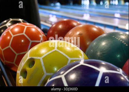 Bowling balls and pins in bowling alley Stock Photo