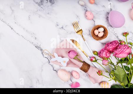 Easter Table Setting with Roses and Gold Cutlery Stock Photo
