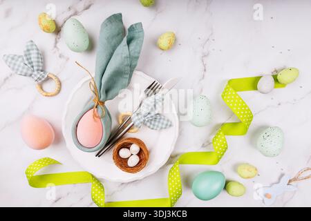 Easter Plate Setting with Bunny Napkin and Green Ribbon Stock Photo