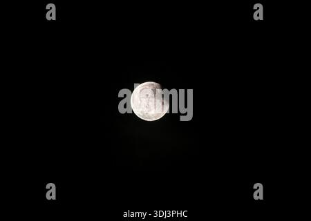 A half-moon brightly illuminated against a dark night sky, eclipse, Italy Stock Photo