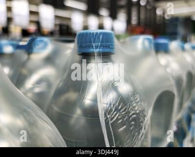 Plastic water bottles wrapped in plastic film in a supermarket, close-up, Cologne, North Rhine-Westphalia, Germany Stock Photo