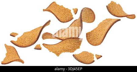 Falling thin rye bread croutons isolated on white background, full depth of field Stock Photo